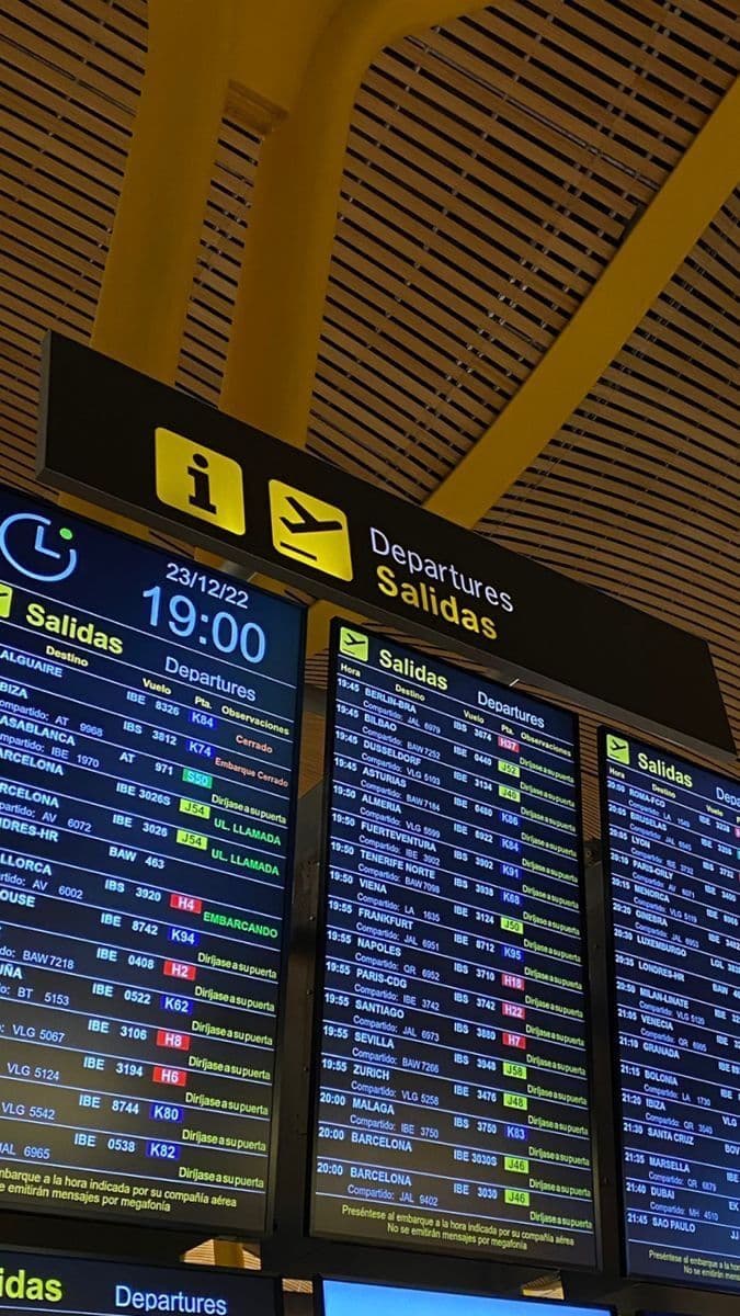 Airport departures board with information and flight signs above it